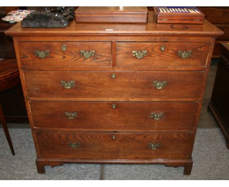 A Georgian oak chest, fitted two short and three long graduated drawers, raised on a shaped apron and bracket feet, 120cm wid