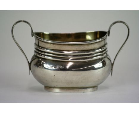 An Edward VII silver sucrier, with reeded decoration and harp shaped handles, London 1905