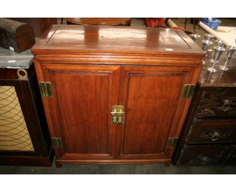 A Chinese hardwood side cabinet, the interior fitted drawers and a shelf enclosed by a pair of panelled doors, 91.5cm wide