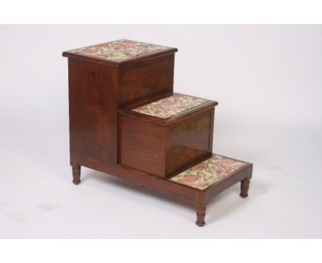 An early 19th Century mahogany three step commode, raised on turned supports