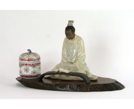 A modern Chinese porcelain figure of a seated scholar reading a book, on hardwood stand; and a Chinese porcelain inkwell, (2)