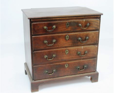 A George III mahogany bachelor's chest, fitted brushing slide and four long graduated drawers, raised on bracket feet, 76cm w