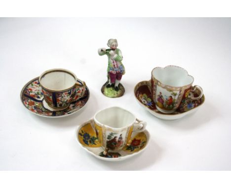 A 19th Century Meissen style chocolate cup and saucer, with figural and floral panel decoration; a smaller similar; a Derby s