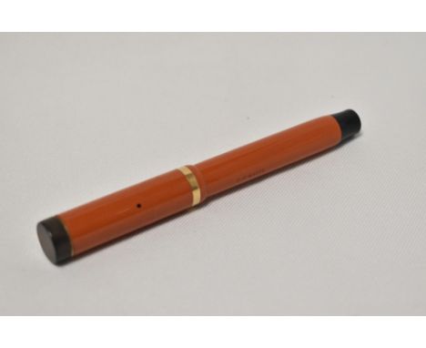 A Parker Duofold Lucky Curve Snr button fill fountain pen in red with single broad band to the cap having Parker Duofold nib.