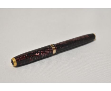 A Parker Vacumatic Jr button fill fountain pen in burgundy with three narrow bands to the cap having Parker Vacumatic nib.