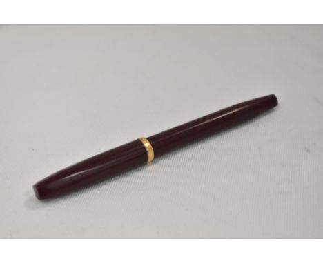 A Sheaffer Imperial piston fill fountain pen in burgandy with band to cap edge, no spot having Sheaffer nib