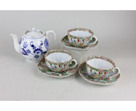 A set of three Chinese Cantonese famille rose scalloped tea cups and saucers, depicting figures in an interior together with 