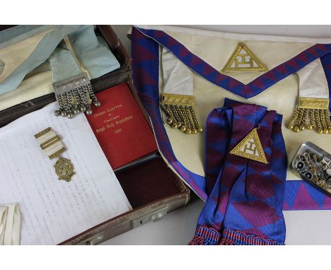 Masonic interest, a silver gilt Masonic medal together with apron, gloves and sash, with assorted paraphernalia in small suit