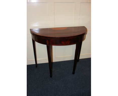 An Edwardian inlaid mahogany demi lune card table, on square tapered legs and spade feet 91cm