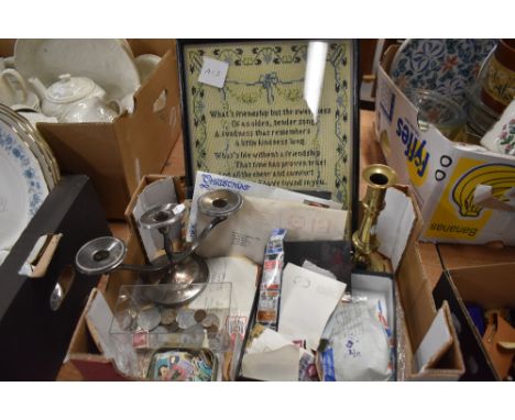 An eclectic lot comprising assorted stamps and coins, silver plated candelabra and brass candlestick and a cross stitch print