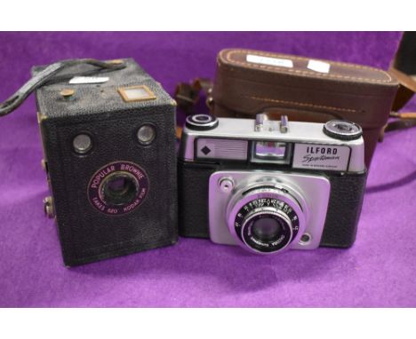 An Ilford Sportsman camera 1:2, 8/45mm Dacora lens and a Popular Brownie camera.