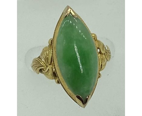 18CT GOLD JADE RING - the ellipse shape stone measuring 21mm x 10mm, slightly cabochon and top mounted with an almost fully c