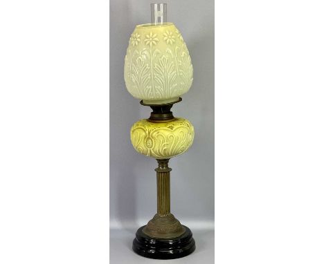 OIL LAMP - Victorian with relief moulded glass font on a brass column and black pottery base having a leaf and floral moulded