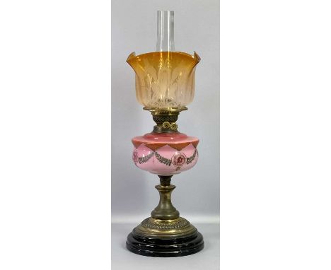 OIL LAMP - Victorian with decorative pink milk glass font on a lacquered brass column and circular black pot base, conical wi