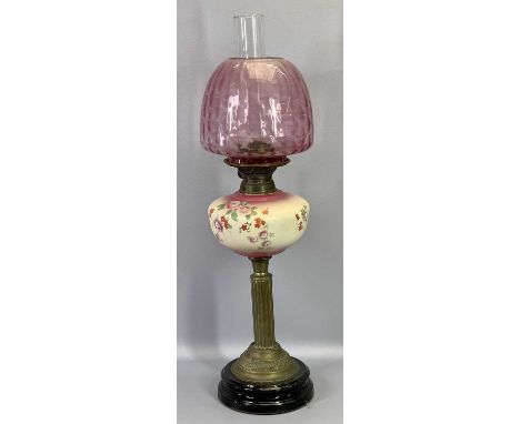 OIL LAMP - Victorian with floral decorated pottery font on a brass column and black pottery base with cranberry tinted shade 