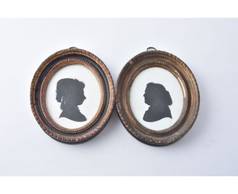 John Miers (British, circa 1758-1821) Portrait of a gentleman   Portrait of a lady   Silhouette painted on plaster 8.5cm (3 3