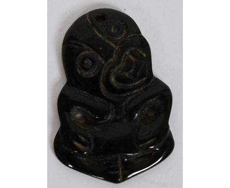 A Maori carved green stone ( jade ) Tiki pendant Of typical form, with suspension hole.