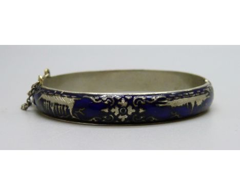 A white metal and blue enamelled bangle 