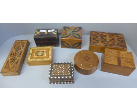 A collection of inlaid wooden boxes, including a card box containing playing cards 