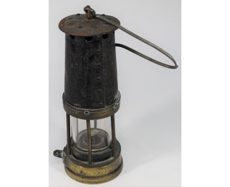 A Davy Miner's Lamp. Brass and steel construction with 212 stamped into brass reservoir section and 667 to top. GC for age, s