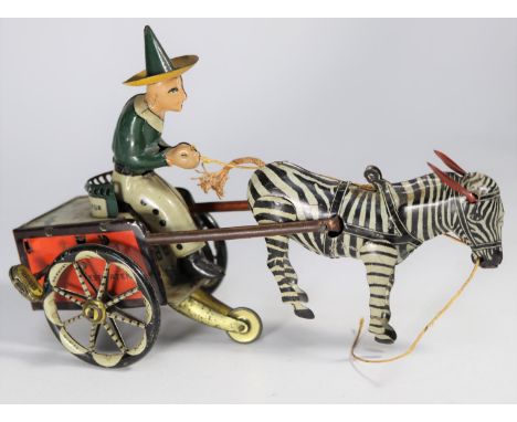 A rare Lehmann 1920s tinplate Zikra Zebra Cart No.752. Clockwork 2-wheel cart with driver in green jacket with green and yell