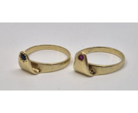 Two 14ct. gold interlocking rings, one gypsy set single round cut ruby, the gypsy set single round cut blue stone, size appro
