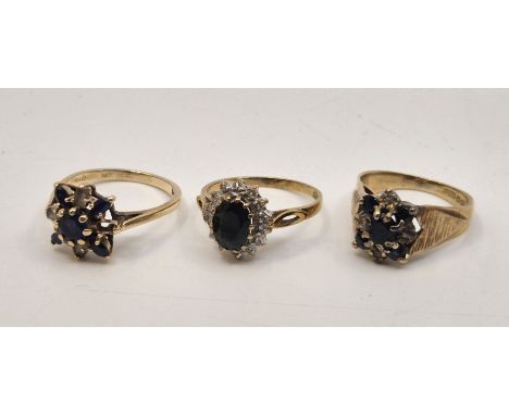 A 9ct. gold, diamond and sapphire ring, set mixed oval cut sapphire to centre bordered by round cut diamonds with pierced sho