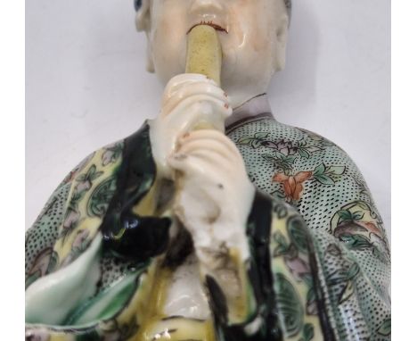 A Chinese porcelain figure of a man playing a flute, height 16.5cm (as found), together with a collection of Chinese plates a