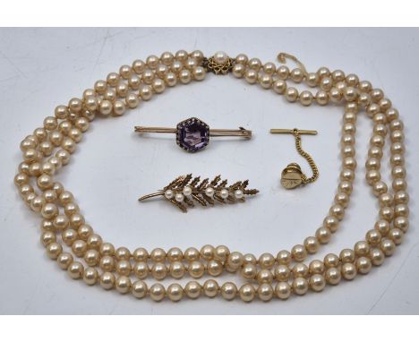 A 9ct. gold and cultured pearl brooch, fashioned as a holly leaf with cultured pearl 'berry' highlights, length 48mm (gross w