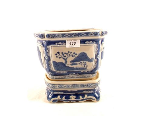 A Chinese blue and white planter with stand decorated with mountain scenes, mark to base