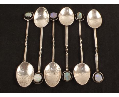 Six Sterling Silver spoons, hand planished and set with Opal stones