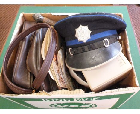 Various fishing reels, tea cards, camera parts and a Police hat etc