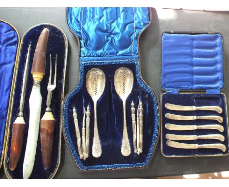 A cased bone handled carving set and part sets, pistol grip Silver handled tea knives and nut cracker part set