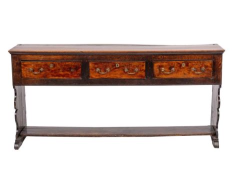 A George II oak dresser, mid 18th century,:  the three frieze drawers all with twin brass swing handles; the sides with shape