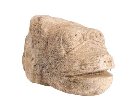 A carved stone corbel: in the form of a fish's head, with open mouth pierced nostrils and eyes, 21.5cm long.