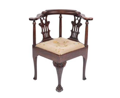A mahogany corner elbow chair in mid 18th Century style, 19th century,: the shaped backrest with outscrolled terminals, on ly
