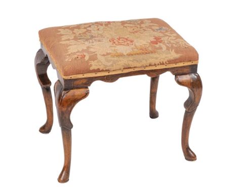 A George II walnut stool, mid 18th century,: the upholstered rectangular seat with tapestry work covering, the rails with ser