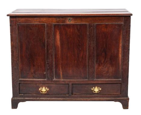 A late George II or George III oak mule chest, mid 18th century,: the hinged rectangular top above a panelled front, with twi