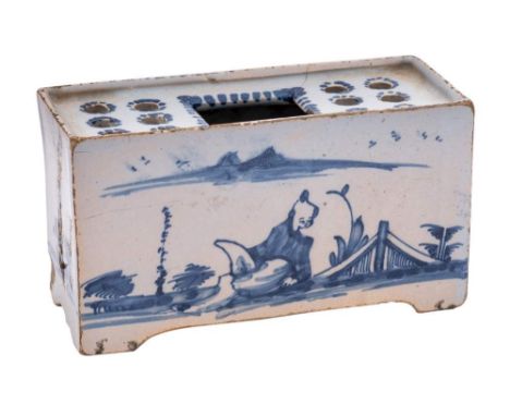 An English blue and white delftware flower brick: of small size, the top pierced with six holes either side of a central rect