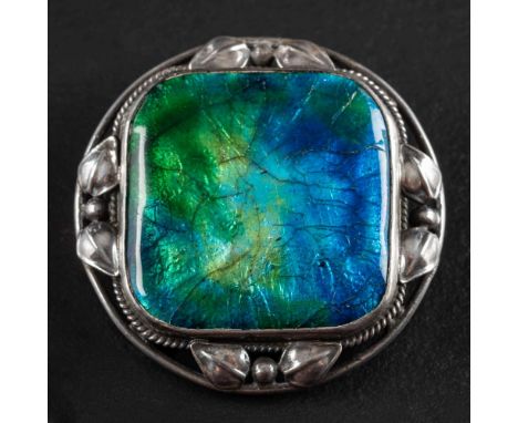 Attributed to Artificers' Guild, a circular blue and green enamel brooch,: within ropework and foliate surround, diameter ca.