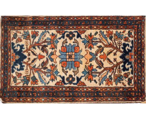 A Quashgai rug:, the light brown field with an all over design of geometric medallions enclosed by a main ivory geometric mea