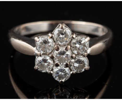 A diamond cluster ring,: set with brilliant cut diamonds, approximately 0.90 carats total, stamped 750 with import marks, rin