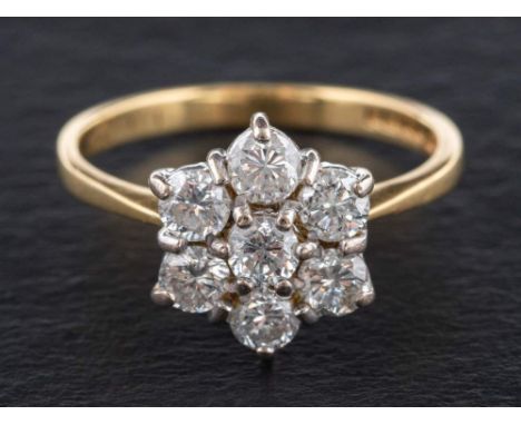 An 18ct gold, round, brilliant-cut diamond cluster ring,: of flowerhead design, estimated total diamond weight ca. 1.05ct, SI