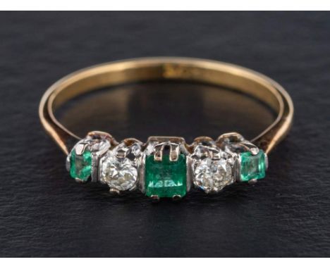 An emerald and round, brilliant-cut diamond five stone ring,: total diamond weight ca. 0.24cts, J-K colour, SI2-P1 clarity, s