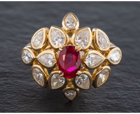 A ruby and diamond cluster ring,: the central oval cut ruby estimated to weigh 1.04 carats, claw set within a surround of pea