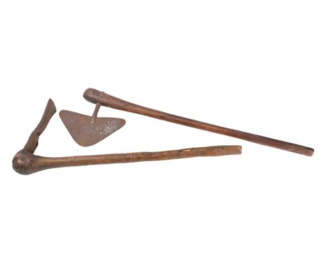  A hand axe: with arrow-shaped steel blade on a slender tapering hardwood handle, 65cm long, together with another axe, 54cm 