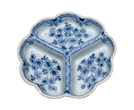 An English blue and white delftware sweetmeat tray: of lobed circular form,  the three compartments painted with a single flo