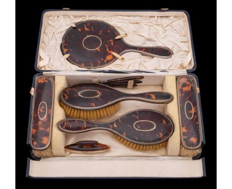 A George V tortoiseshell and silver mounted dressing table set, maker William Comyns & Sons Ltd, London, 1927: includes two h