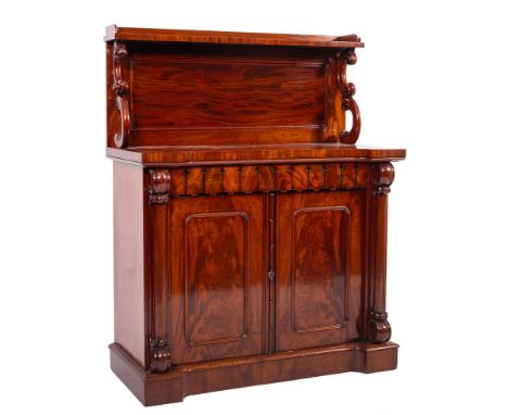 A Victorian mahogany chiffonier, circa 1870,: the upper shelf with three quarter gallery above a panel back and twin scroll c