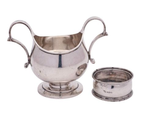 A George V silver twin handled basin, maker Blackmore &amp; Fletcher, London, 1915: with scrolling loop handles to the side, 